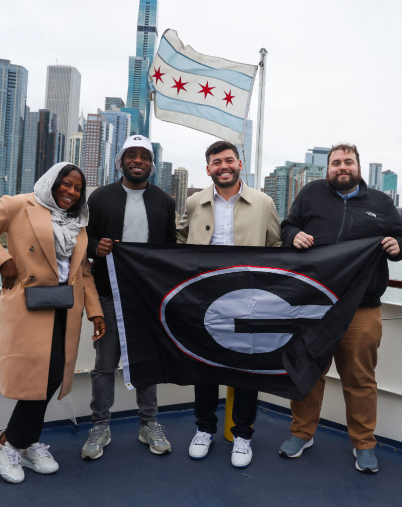 Group of Friends Holding University of Georgia Flag in Chicago