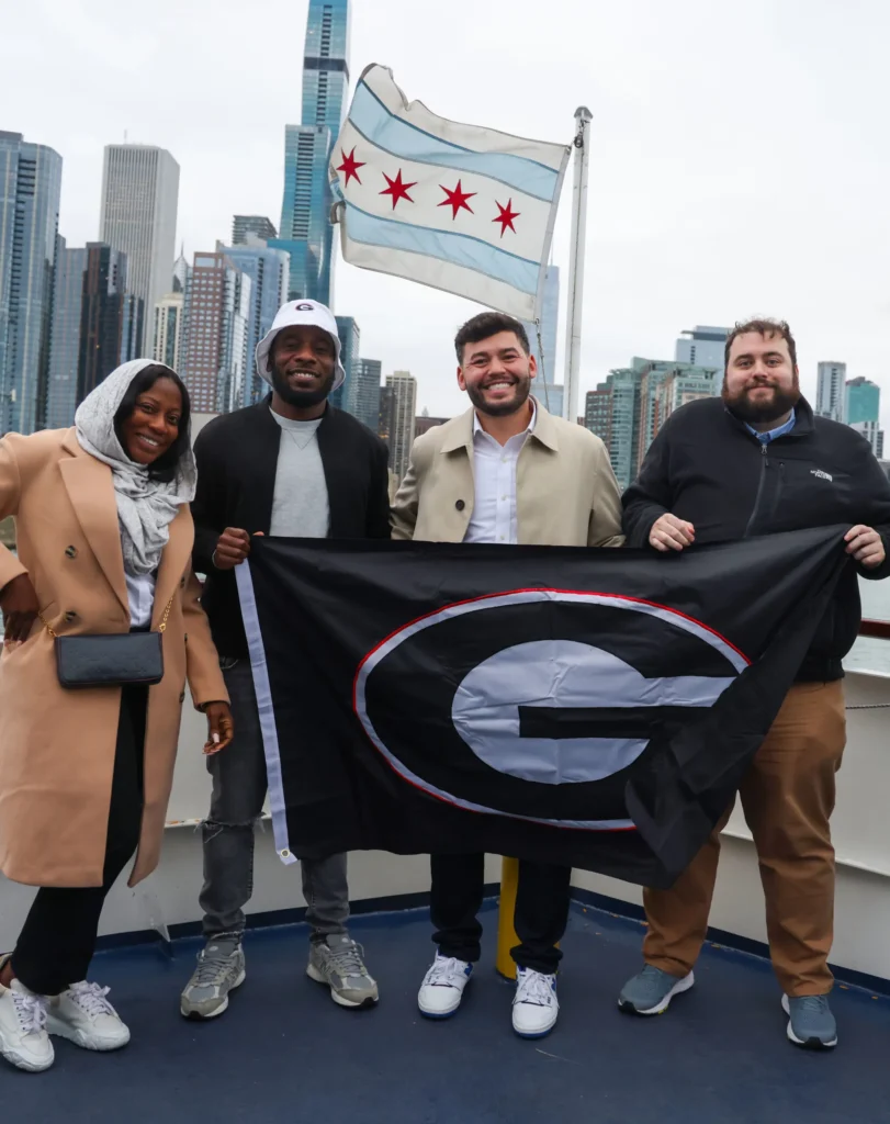 Group of Friends Holding University of Georgia Flag in Chicago