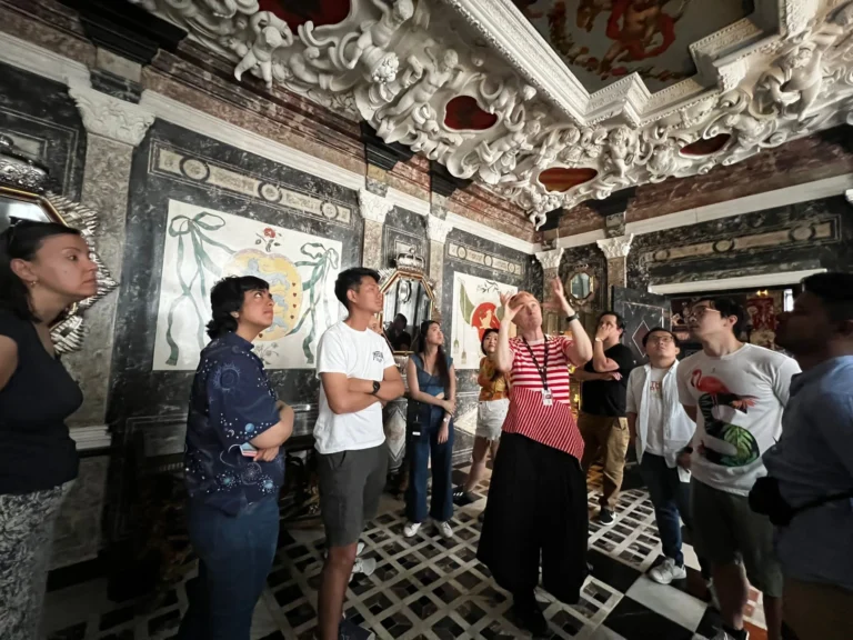 Tour group admiring the ornate ceiling at Rosenborg Castle in Denmark